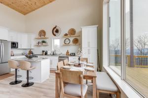 a kitchen with white cabinets and a table and chairs at Mtn-View 'Hidden Falls' Cabin w/ Hot Tub & Deck in Andrews