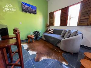 a living room with a couch and a fish rug at BECA Residencial in Canoa Quebrada