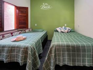 two beds sitting next to each other in a room at BECA Residencial in Canoa Quebrada