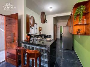 a kitchen with a counter and a refrigerator at BECA Residencial in Canoa Quebrada
