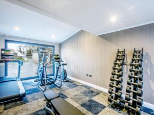 a gym with two treadmills and two exercise bikes at Lodge 74 at Riviera Bay Coastal Retreat in Brixham