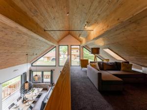 a living room with a large wooden ceiling at Alpinn Wellness 2 in Sankt Margarethen im Lungau