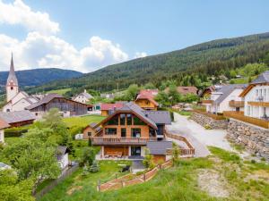 a village in the mountains with a church at Alpinn Wellness 2 in Sankt Margarethen im Lungau