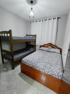 a bedroom with two beds and a table and a chair at Chácara Rancho Imperial - Socorro - SP - Piscina, Churrasqueira, Forno à Lenha, Campo de Futebol e uma linda Vista para a Montanha! in Socorro +40 photos