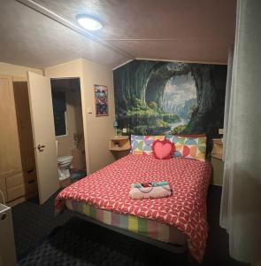 a bedroom with a bed with a painting on the wall at The Rainbow's nest in Morecambe +12 photos