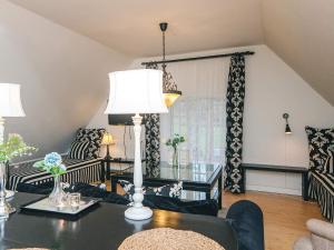 a living room with a table with a lamp at Spacious holiday home with garden in Skanderborg +4 photos