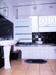 a bathroom with a sink and a toilet in it at Wakanda in Johannesburg