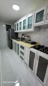 a kitchen with white cabinets and a counter top at Obynb in Santo Domingo