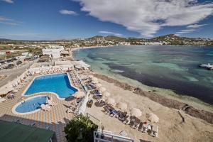 an aerial view of a beach with a swimming pool and the ocean at Hotel Argos Ibiza in Talamanca