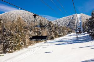 a ski lift going up a snow covered mountain at High Pines Haven in Angel Fire