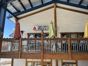 a restaurant with umbrellas and tables in front of a building at High Pines Haven in Angel Fire +18 photos