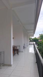 an empty corridor of a building with white walls at Saphala Suites Secondfloor in Seminyak