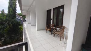 a balcony of a house with a table and chairs at Saphala Suites Secondfloor in Seminyak