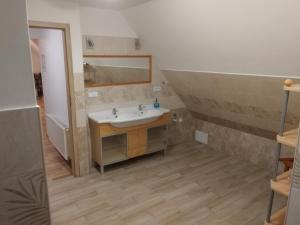 a bathroom with a sink and a mirror at Apartmány u Martina in Javorník +112 photos