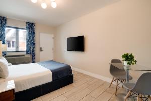 a hotel room with a bed and a table and chairs at Waterside Hotel and Suites in Miami Beach