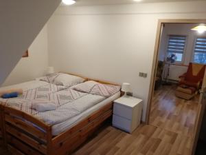 a bedroom with a bed and a chair at Apartmány u Martina in Javorník