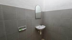 a bathroom with a sink and a mirror at Saphala Suites Secondfloor in Seminyak