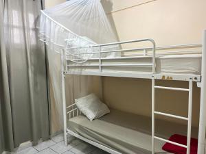 a bunk bed in a small room with a bunk bedutenewayangering at La Belle Escapade in Quartier du Fond Fleuri