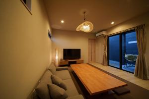 a living room with a couch and a table at 湯宿灯火 in Beppu