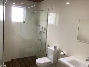 a bathroom with a shower and a toilet and a sink at Viewfront Ella in Ella