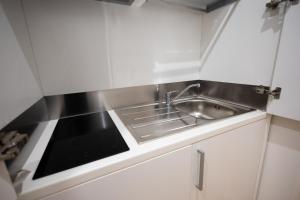 a small kitchen with a sink and a stove at Barberini Design Suites in Rome