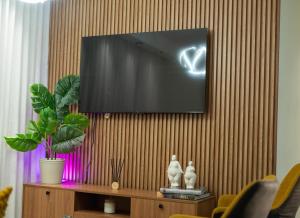 a flat screen tv hanging on a wall at San Isidro Urban suite in Juan López
