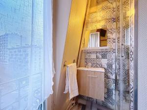 a bathroom with a sink and a mirror at Au Fleuri hotel in Paris