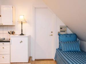 a kitchen with a blue chair next to a door at 4 star holiday home in Skanderborg in Skanderborg