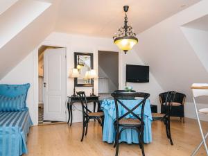 a dining room with a table and chairs at 4 star holiday home in Skanderborg in Skanderborg +4 photos