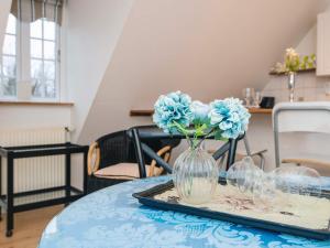 a vase with blue flowers sitting on a table at 4 star holiday home in Skanderborg in Skanderborg