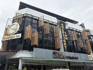 a building with a clock on the side of it at Goldlight Inn in Miri