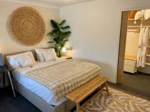a bedroom with a bed and a table and a mirror at White Rabbit Mountain Guest House in Mount Beauty