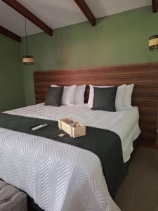 a bedroom with two beds with a box on it at Olla é Mono Ecolodge in Sarapiquí