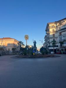 a parking lot with a statue in front of a building at B&B La Rotonda in Frattamaggiore