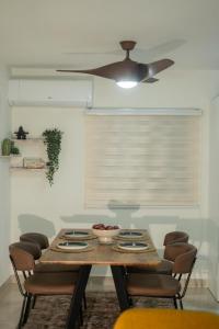 a dining room table with chairs and a ceiling fan at San Isidro Urban suite in Juan López +24 photos