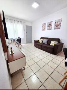 a living room with a couch and a table at Apto Completo Ar e Wi-Fi Parque Itaimbe in Santa Maria