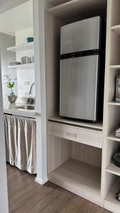 a cabinet with a microwave in a kitchen at Inn on The Park in Honolulu