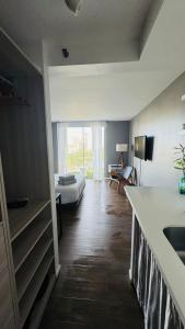 a room with a kitchen and a living room with a couch at Inn on The Park in Honolulu