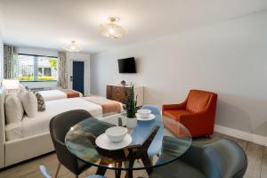 a living room with a couch and a table and chairs at Waterside Hotel and Suites in Miami Beach +48 photos