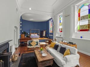 a living room with a couch and a table at The Music Room in Aveton Gifford