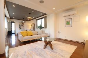 a living room with a couch and a table at Yokohama Mega Stay in Yokohama