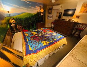 a bedroom with a bed with a painting on the wall at Itty Bitty Inn in North Bend