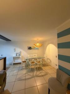 a living room with a table and chairs at Departamento frente a la playa in Arica