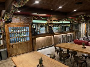 a restaurant with tables and a bar with wine bottles at Ski-in, Ski-out Iwatake Apartments in Hakuba