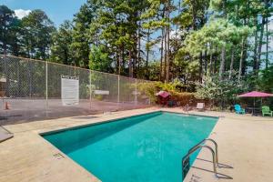 a swimming pool with a fence around it at Lucky #9 Hot Springs in Hot Springs