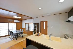 a kitchen and dining room with a dining table at わとなみ in Tonosho