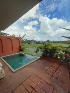 a swimming pool in the middle of a patio at Buduk villa in Dalung