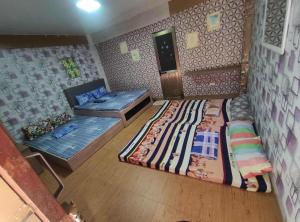 a room with two beds and a couch in it at U&R Bay View Beach Resort in Burgos +3 photos