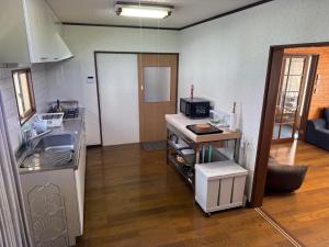 a kitchen with a sink and a counter top at 2 Peaks Snow Lodge in Hakuba