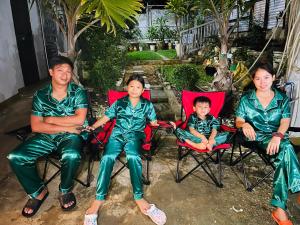 a group of three people sitting in chairs at U&R Bay View Beach Resort in Burgos